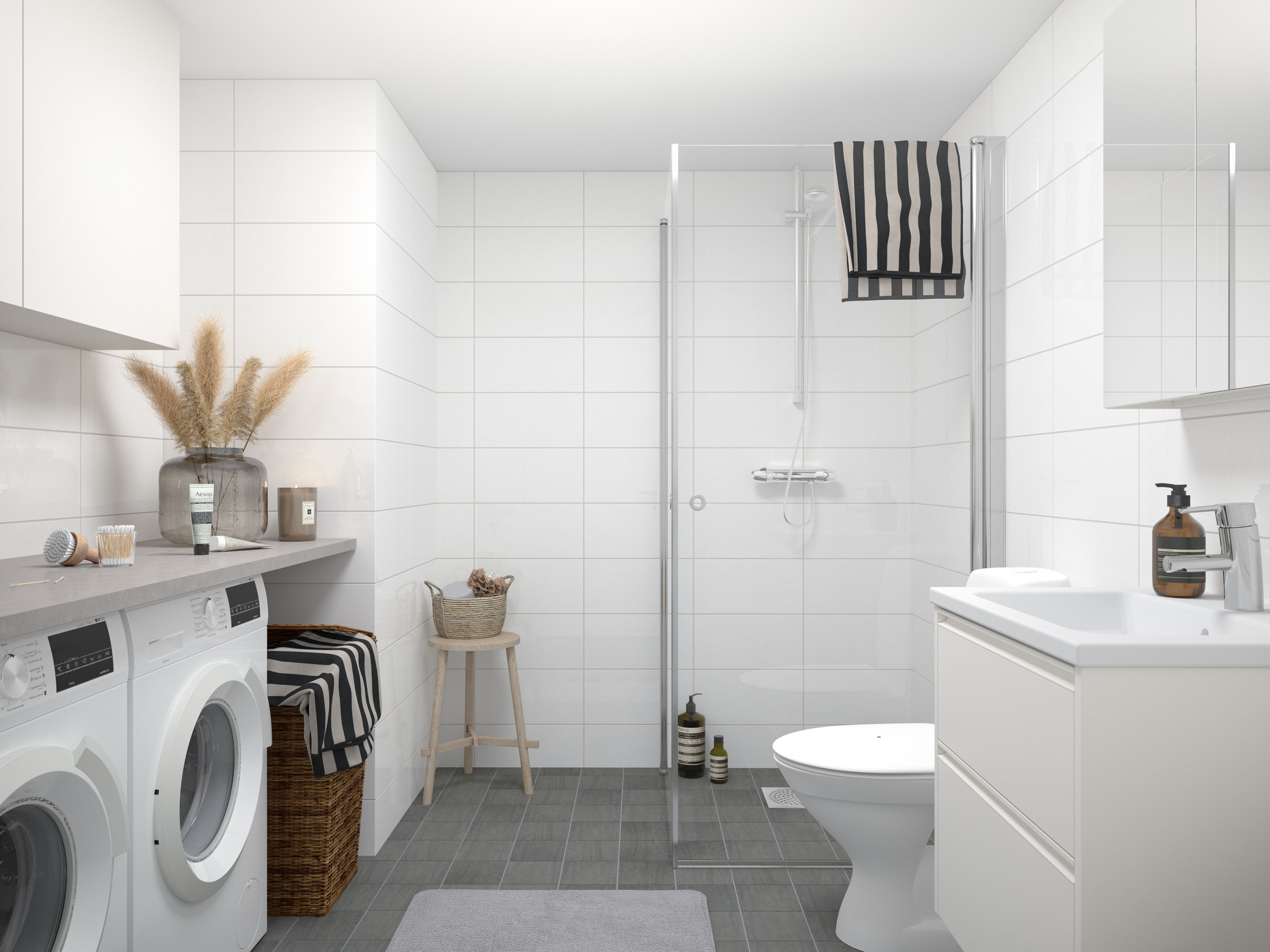 Ett badrum med tvättmaskin och torktumlare i Brf Kvisljungeby Ängar.