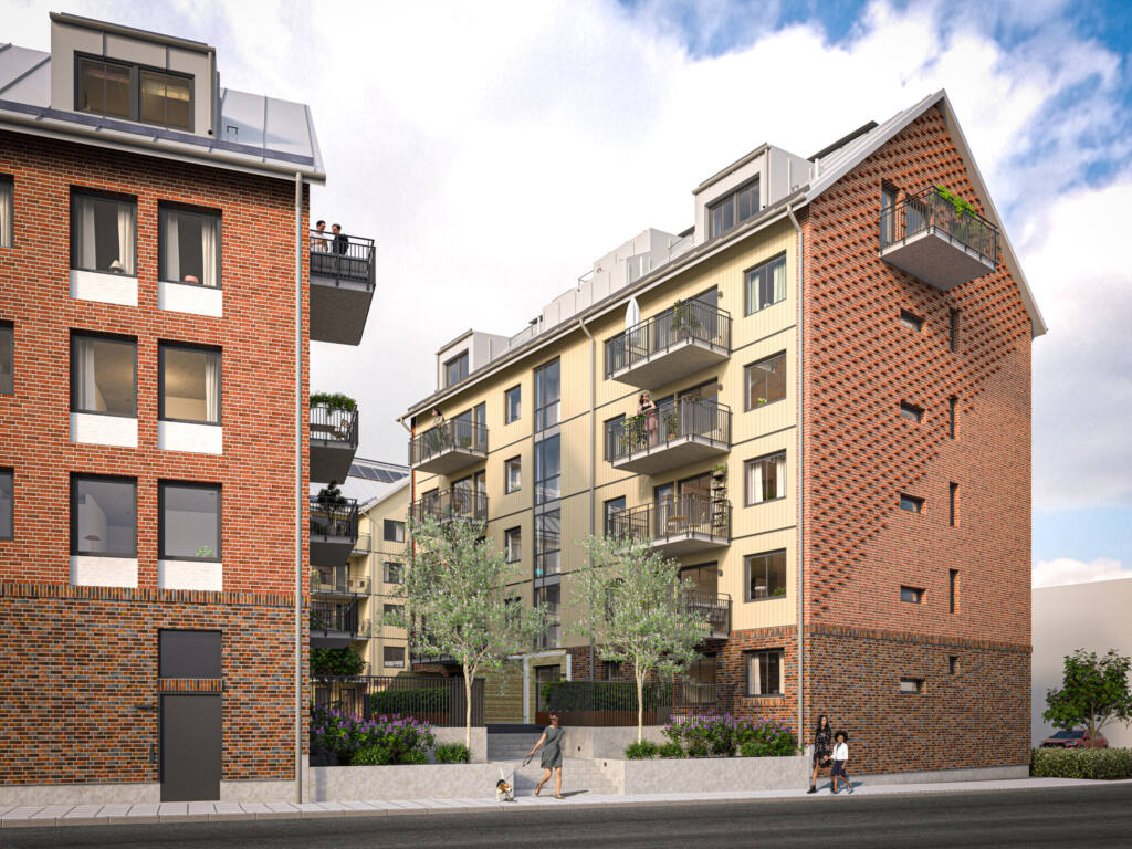 Flerbostadshus med bostadsrätter. Fasad i rött tegel och ljus träpanel.